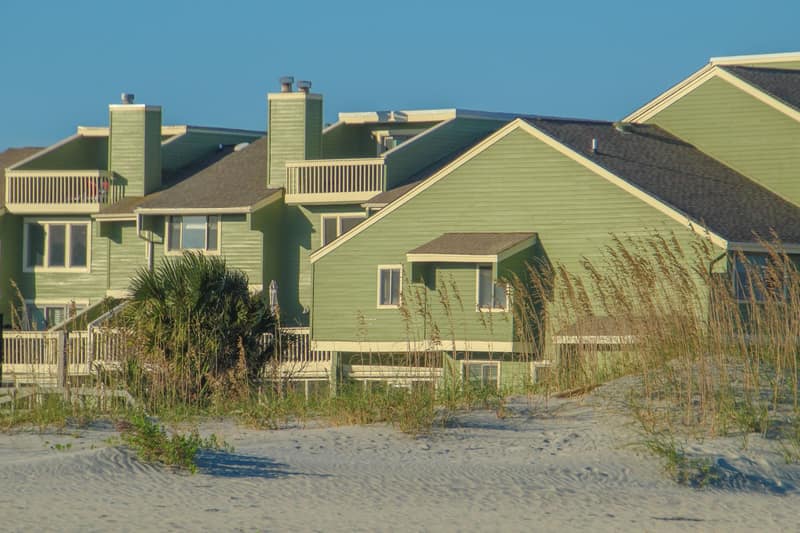 Vacation homes beside the beach under a sunny sky