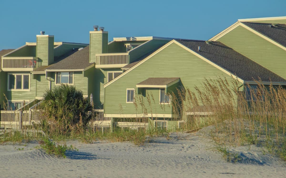 Vacation homes beside the beach under a sunny sky